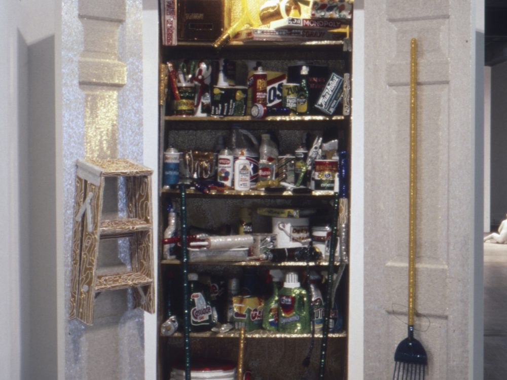 This photograph of the installation which appears to be a normal utilities closest but upon closer look, everything is covered with shiny beads
