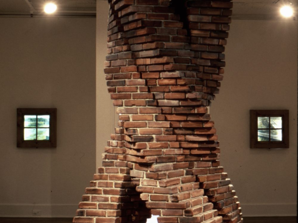 This is a photograph of an installation which appears to be a twisting smoke stack