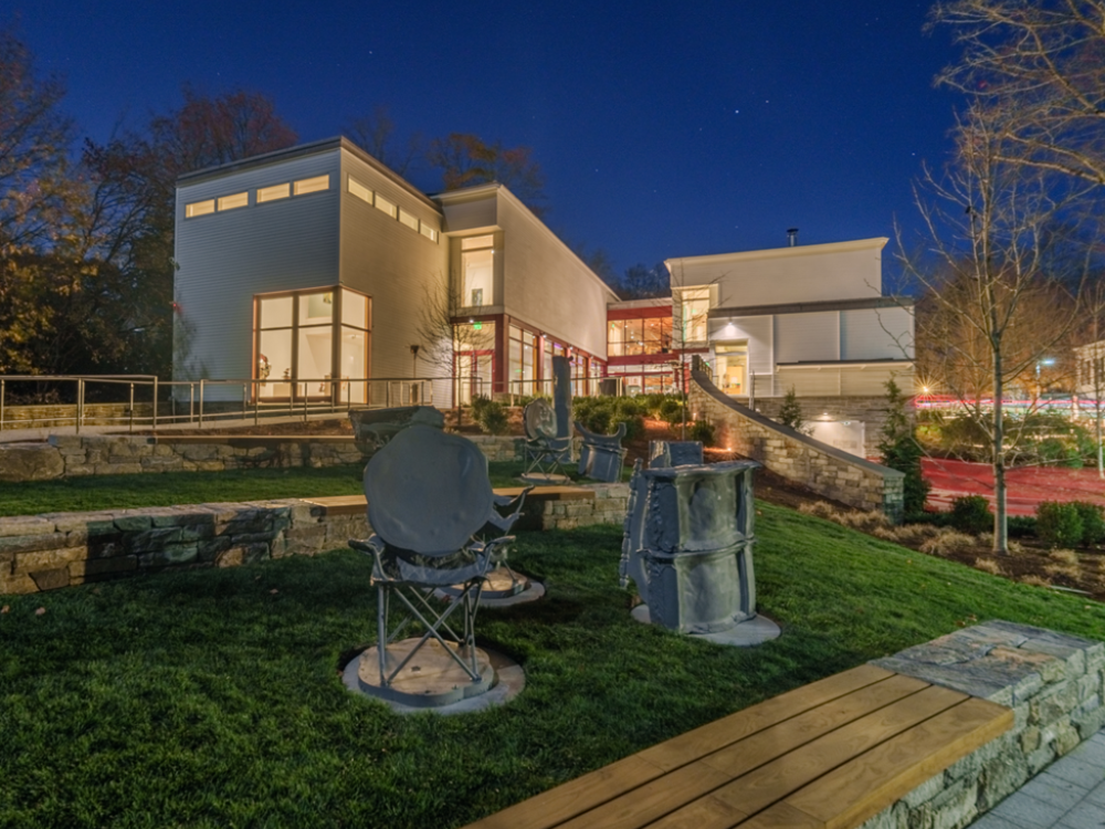 Exterior image of the museum and sculpture garden in a night setting