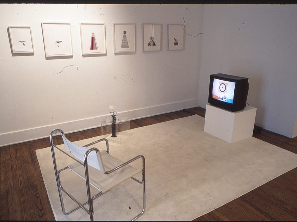 This is a photograph from the Pop Surrealism exhibition which featured this installation that included an empty chair facing a curated television program