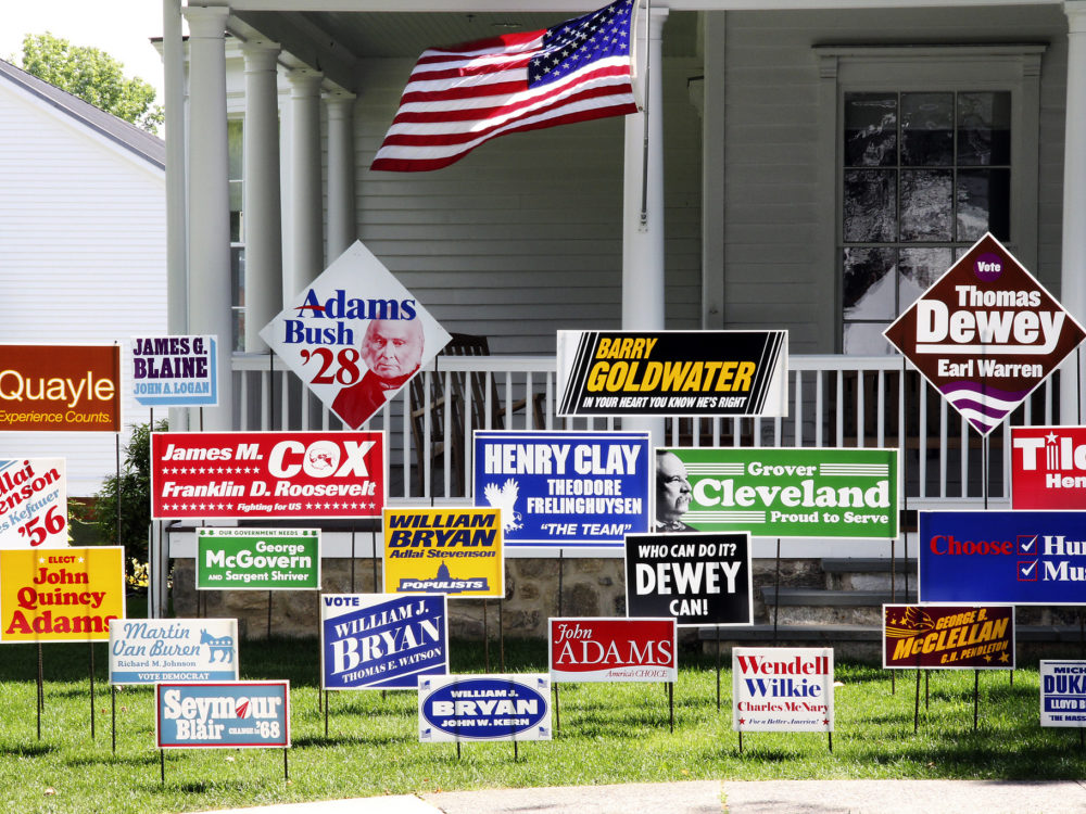 Political yard signs sit on the front lawn of the Museum's Old Hundred building
